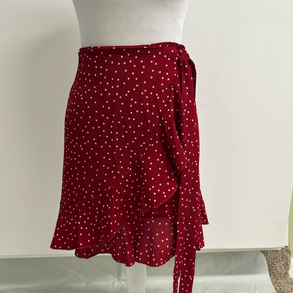 Wrap around mini skirt with ruffles - red polka dots.